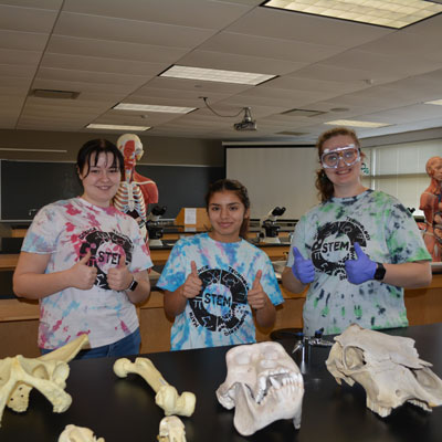 Three students in a science lab