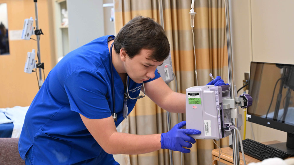 Nursing student training in a simulated hospital room