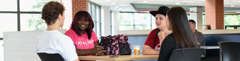 Four students sitting around a table