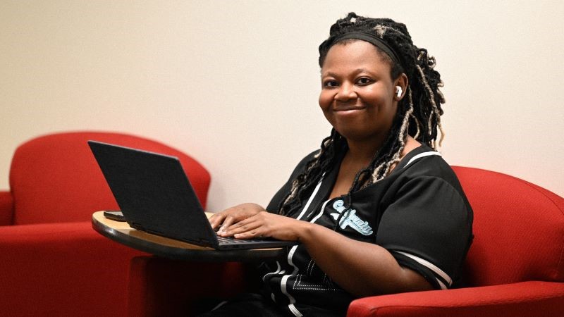  Student Tyreanna Jarrett sitting in the resting area going through notes on laptop