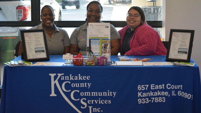 Three employees of Kankakee County Community Services team smiling at the camera